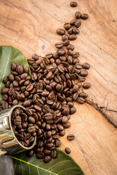 Roasted Columbian coffee beans placed on a wooden table. - Photo, Image