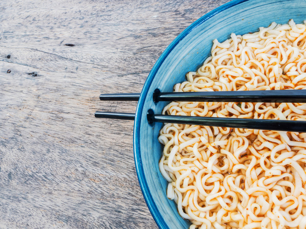 spicy instant noodles in bowl with chopsticks - Photo, Image