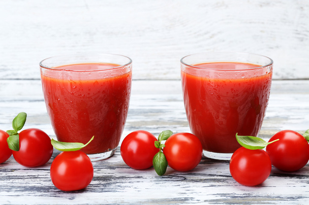 Glasses of tomato juice with vegetables on wooden background - Фото, изображение