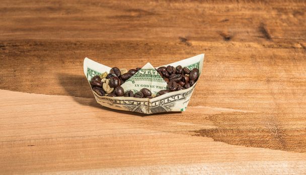 Boat banknote charge of coffee beans . - Photo, Image