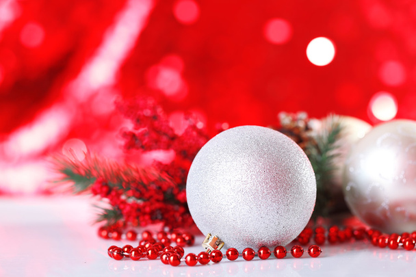 Beautiful Christmas balls on red blurred background - Foto, Imagen
