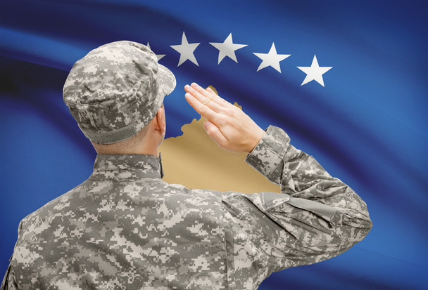 Soldier in hat facing national flag series - Kosovo - Foto, imagen