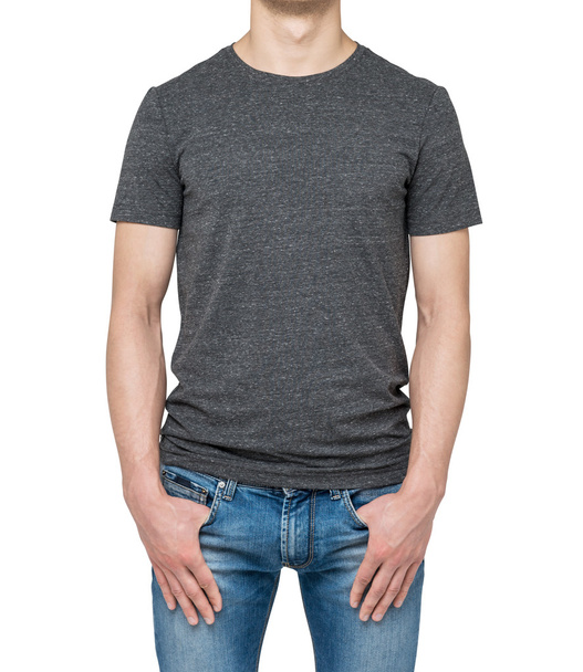 Close-up of a man in a blank grey t-shirt. Hands in the denims pockets. Isolated. - Foto, imagen