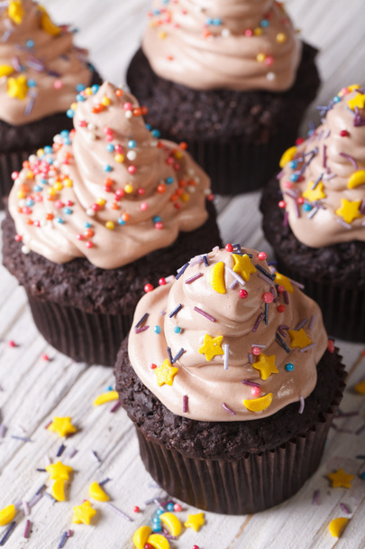 Chocolate cupcakes decorated with delicate cream close-up. verti - Photo, Image