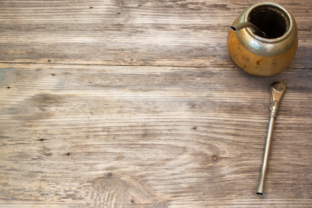 Calabash and bombilla with yerba mate on wooden background. Copy space to right. - 写真・画像