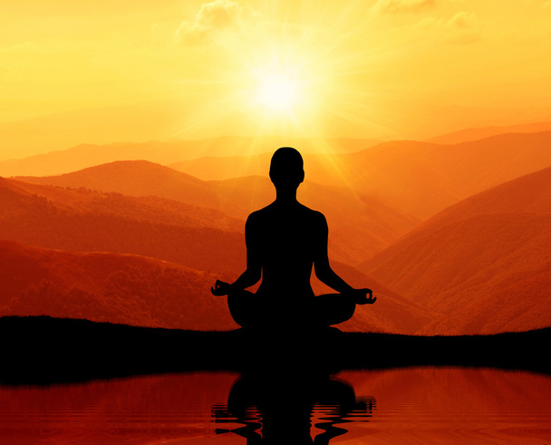 Man meditating in yoga position on the top of mountains - Photo, Image