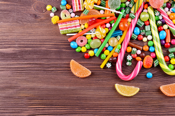 Colorful candies on wooden background - Fotó, kép