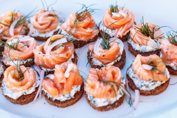Snacks with salmon on plate. - 写真・画像