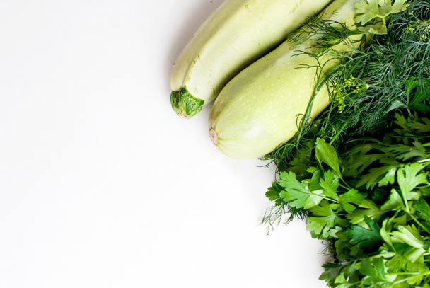 young zucchini with parsley on a white background - Photo, Image