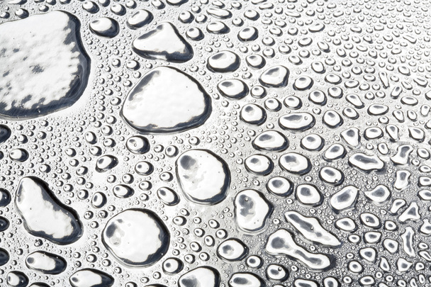 Water drops on polished metal surface - Foto, afbeelding