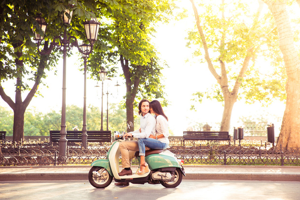 trendy couple riding a scooter in the morning - Valokuva, kuva