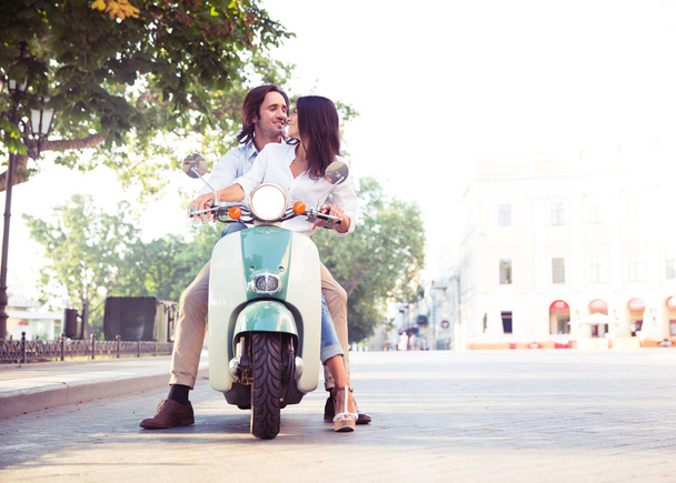 Happy european couple flirting on scooter - Valokuva, kuva