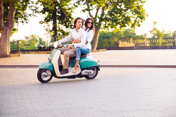 trendy couple riding a scooter in the morning - Fotoğraf, Görsel