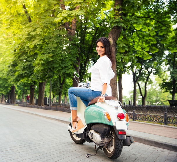 Happy young woman on a scooter - Valokuva, kuva