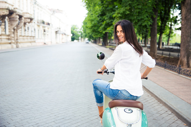 eautiful woman riding a scooter - Foto, Imagen