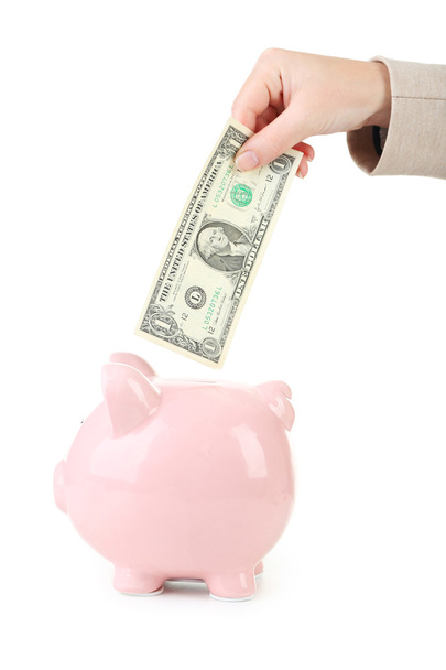 hand putting dollar  into pink piggy bank - Фото, изображение