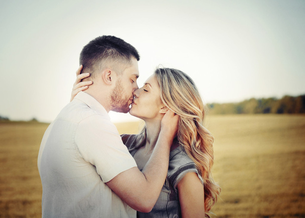 stunning sensual young couple in love kissing at the sunset in f - Photo, Image