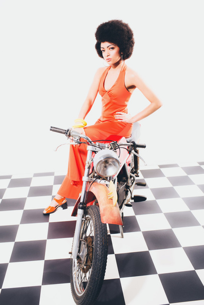 Beauty portrait of an elegant lady on a motorbike - 写真・画像