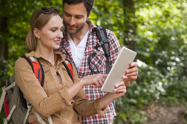 Couple using digital tablet in trip - Photo, image