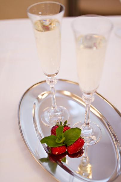Two champaign glasses and strawberries isolated on white background - 写真・画像