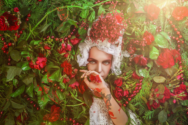 Fairy tale woman portrait surrounded with natural plants and roses. Art image in bright fantasy stylization. - Фото, изображение