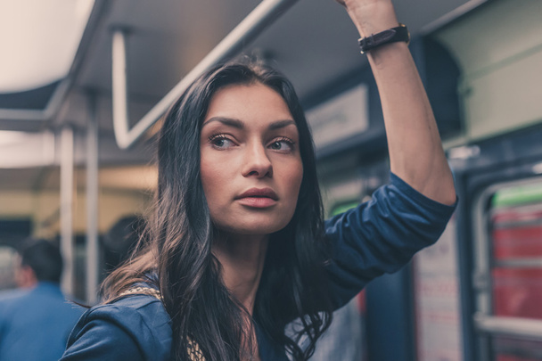 Beautiful girl posing in a metro car - Foto, Imagen