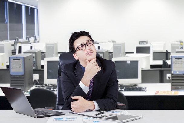 Pensive manager thinking a plan in office - 写真・画像