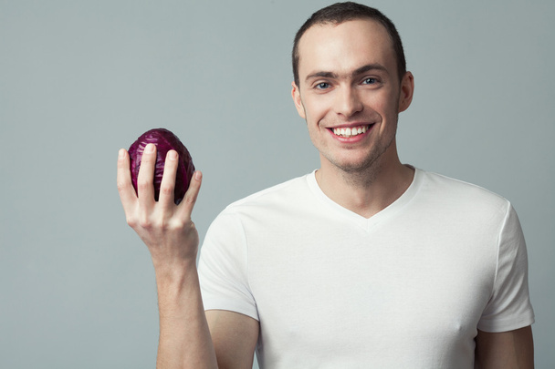Raw, living food concept. Portrait of happy young man - 写真・画像