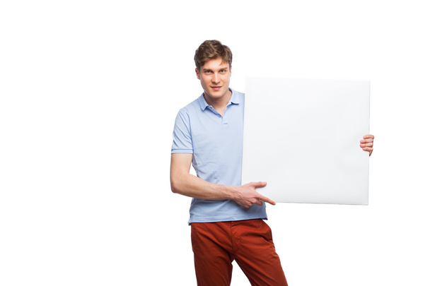 young blonde man showing empty panel isolated on white - Φωτογραφία, εικόνα