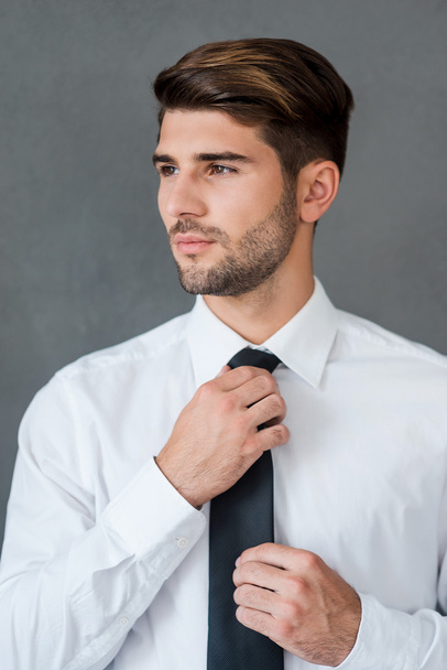 businessman adjusting his necktie - Zdjęcie, obraz