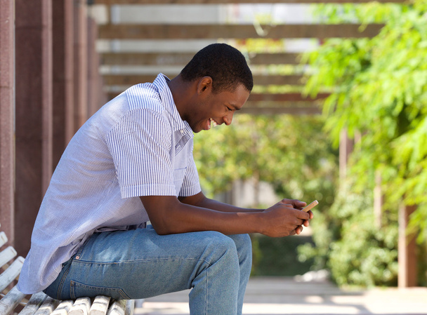 Fajny facet african american patrząc na telefon komórkowy  - Zdjęcie, obraz