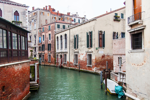 VENICE, ITALY - on MAY 3, 2015. The typical Venetian street canal and old houses on coast - 写真・画像