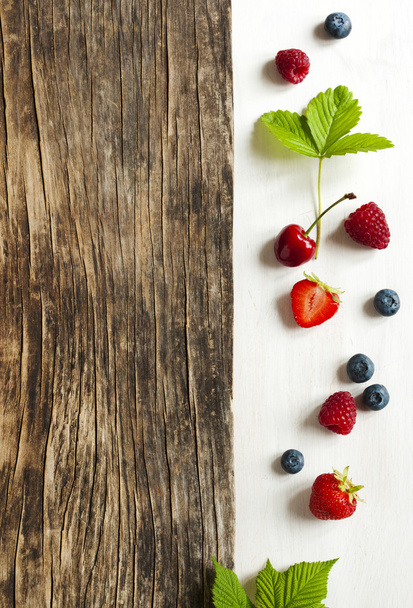 Wooden background with summer berries and copy space - Foto, Bild