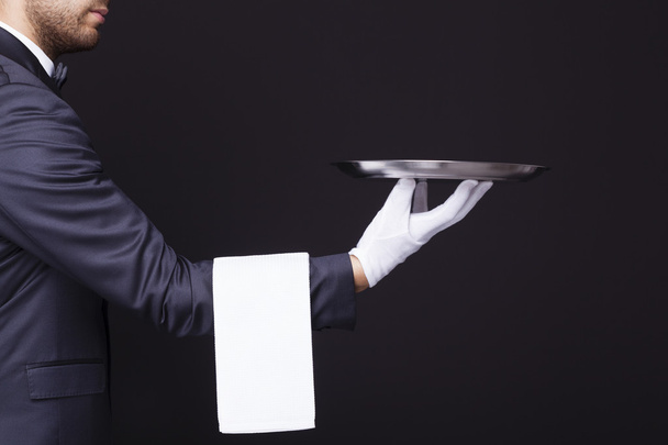 waiter holding an empty silver tray - Foto, Imagen