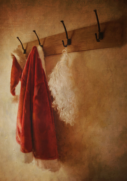 Santa costume hanging on coat rack - Foto, afbeelding