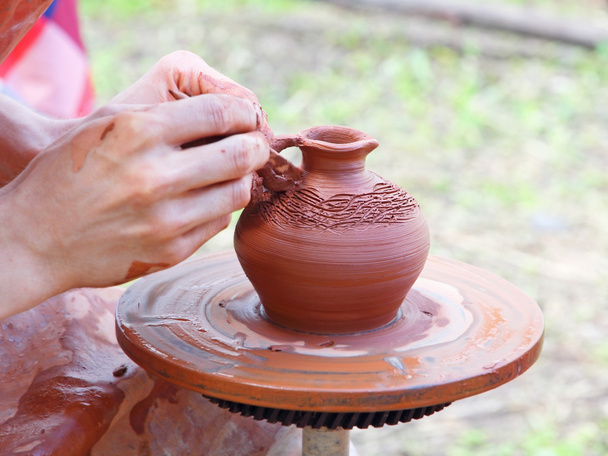 Potter makes on pottery wheel clay pot. - Photo, Image