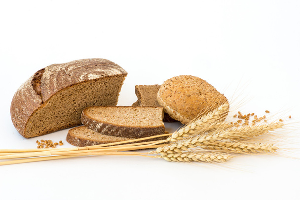 Variety of bread and stalks of wheat isolated on white - Φωτογραφία, εικόνα