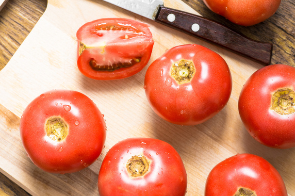 Chopping board, whole tomato, slice and knife top view - Foto, Imagem