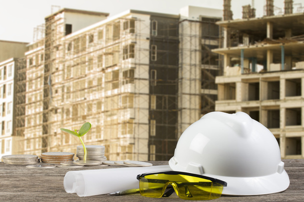 Business Growing  file of safety helmet and architect plant on wood table with  construction - Photo, Image