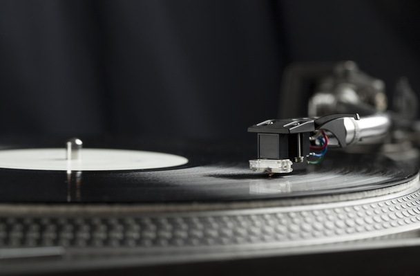 Turntable playing vinyl close up with needle on the record  - Photo, Image