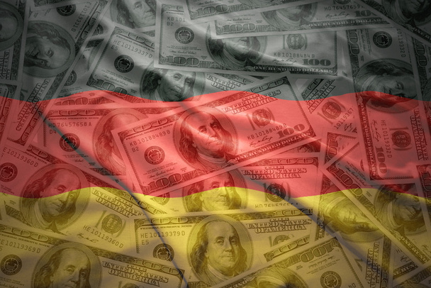 Colorido ondeando bandera alemana en un dólar americano dinero
 - Foto, Imagen