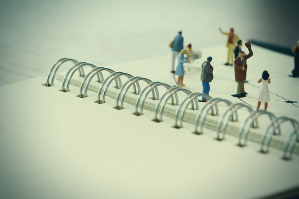 close up of miniature people with social network diagram on open - Photo, Image
