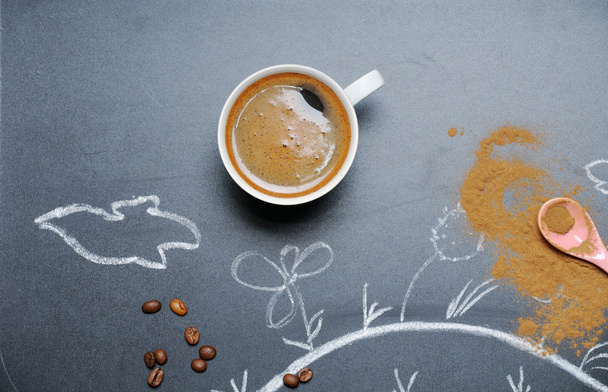 mug of coffee with happy drawing and cinnamon on the blackboard  - Photo, Image