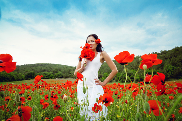 portrait of a beautiful woman in a field with flowers - Photo, image