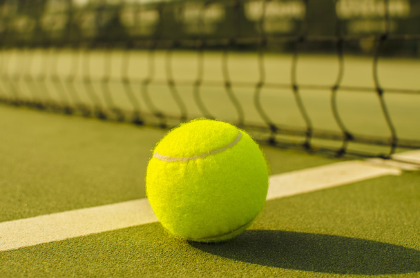 Tennis Ball on the Court with the Net in the background  - Foto, Imagen