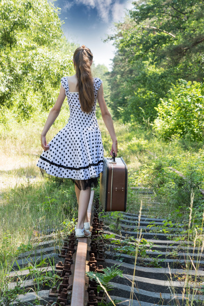 Fashion girl with suitcase at railways - Φωτογραφία, εικόνα