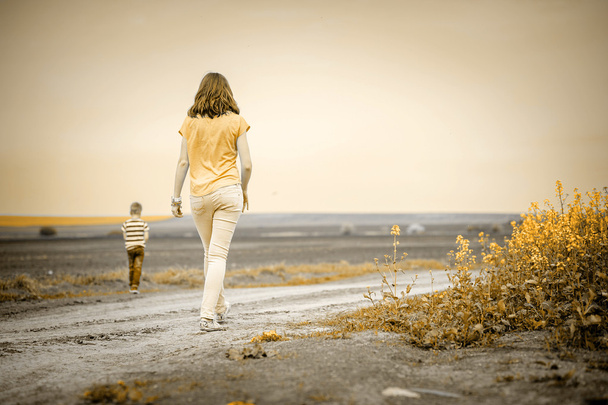 Young woman walking with son - Φωτογραφία, εικόνα
