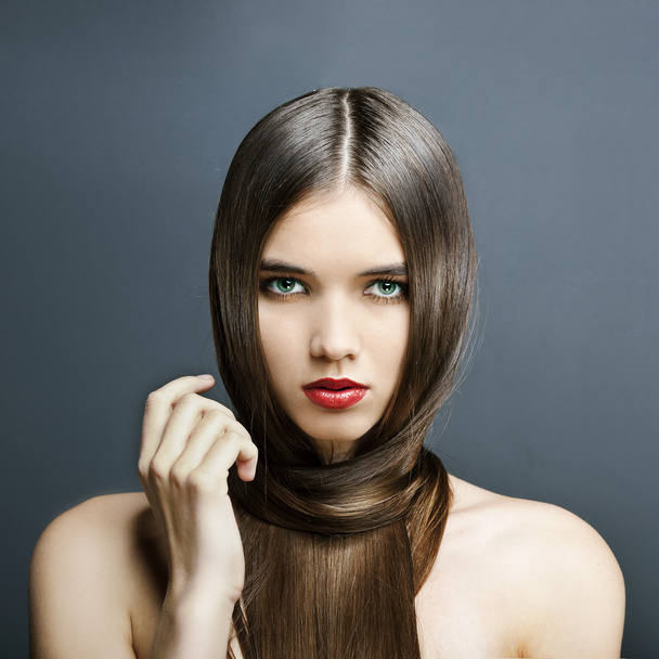 Beautiful girl with perfect skin, red lipstick and long, smooth hair - 写真・画像