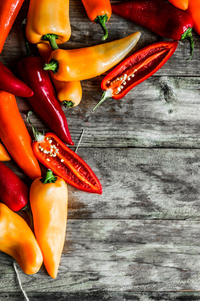 Colorful peppers on rustic background - Фото, изображение