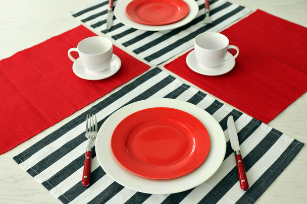 Table setting with red and striped napkins - Φωτογραφία, εικόνα